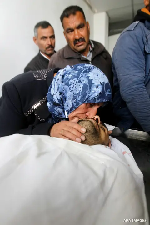 The mother of Qassem Jaber, a Palestinian who was shot dead following reported attacks on Israelis, mourns during his funeral on March 15, 2016 in the West Bank town of Hebron. Three Palestinians, Qassem Jaber, 30, and A...