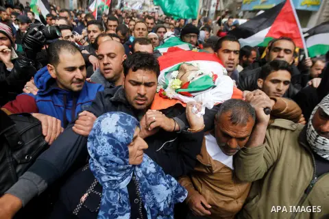 Mourners carry the body of Qassem Jaber, a Palestinian who was shot dead following reported attacks on Israelis, during his funeral on March 15, 2016 in the West Bank town of Hebron. Three Palestinians, Qassem Jaber, 30,...