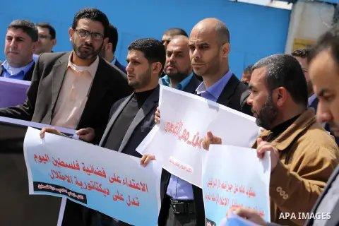 Palestinian employees of Al-Aqsa TV carry placards during a protest outside the United Nations Office in Gaza City on March 15, 2016, against the decision to halt transmission of the channel by the French satellite Eutel...