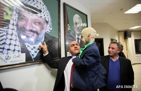 Five-year-old Ahmed Dawabsha, a Palestinian boy who survived a firebombing by Jewish extremists targeting his family home that killed his parents and brother, meets with the governor of the northern Palestinian town of N...