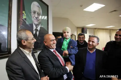 Five-year-old Ahmed Dawabsha, a Palestinian boy who survived a firebombing by Jewish extremists targeting his family home that killed his parents and brother, meets with the governor of the northern Palestinian town of N...