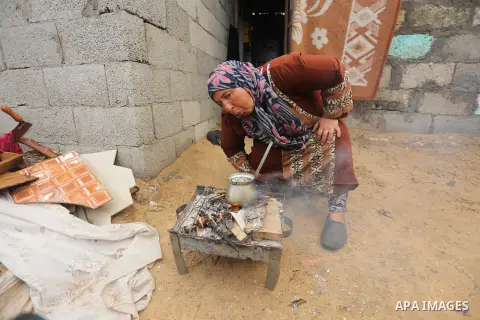 Palestinian woman Jihan Abu Muhsen makes tea before going to work collecting bricks for sale from the sites of demolished buildings, at her dwelling in Khan Younis in the southern Gaza Strip March 17, 2016. Abu Muhsen ga...