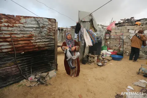 Palestinian woman Jihan Abu Muhsen collects bricks for sale with her son Mohammad from the ruins of a house destroyed during the 2014 war in Khan Younis in the southern Gaza Strip March 17, 2016. Abu Muhsen gathers brick...