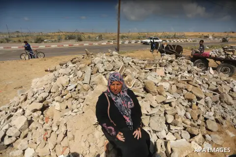 Palestinian woman Jihan Abu Muhsen, who collects bricks for sale from the sites of demolished buildings, poses for a photo in Khan Younis in the southern Gaza Strip March 17, 2016. Abu Muhsen gathers bricks from the site...