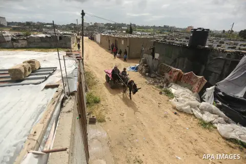 Palestinian woman Jihan Abu Muhsen rides her donkey-drawn cart as she collects bricks for sale from the sites of demolished buildings in Khan Younis in the southern Gaza Strip March 17, 2016. Abu Muhsen gathers bricks fr...