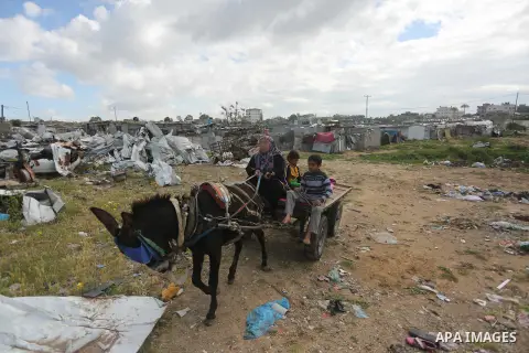 Palestinian woman Jihan Abu Muhsen collects bricks for sale with her son Mohammad from the ruins of a house destroyed during the 2014 war in Khan Younis in the southern Gaza Strip March 17, 2016. Abu Muhsen gathers brick...