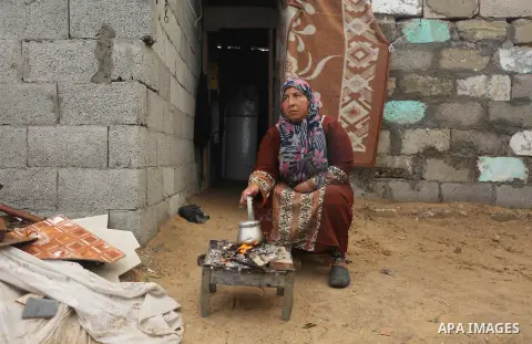 Palestinian woman Jihan Abu Muhsen makes tea before going to work collecting bricks for sale from the sites of demolished buildings, at her dwelling in Khan Younis in the southern Gaza Strip March 17, 2016. Abu Muhsen ga...