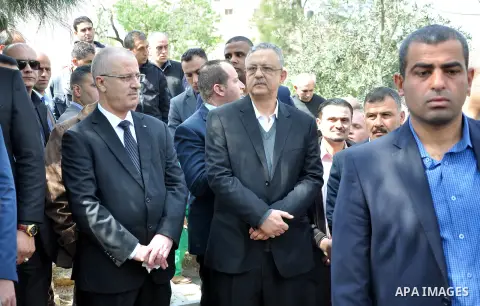 Palestinian Prime Minister Rami Hamdallah attends the funeral of 16 Palestinians, who lost their lives in overturned bus accident in Jordan on their way to Saudi Arabia for umrah in the West Bank village of Deir al-Ghoss...