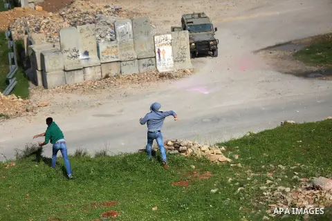Palestinian protesters clash with Israeli security forces on March 18, 2016, following a demonstration in solidarity with Palestinian prisoners held in Israeli jails, outside the compound of the Israeli-run Ofer prison n...