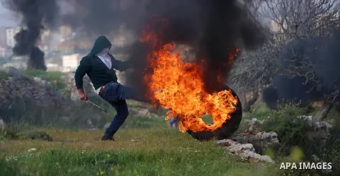 Palestinian protesters clash with Israeli security forces on March 18, 2016, following a demonstration in solidarity with Palestinian prisoners held in Israeli jails, outside the compound of the Israeli-run Ofer prison n...