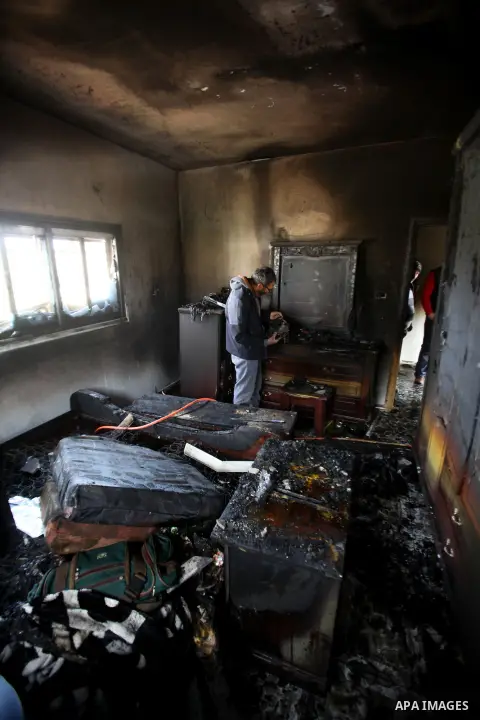 A Palestinian man inspects the damage to the torched house of Ibrahim Dawabsheh, the main witness in the July arson attack that killed a Palestinian family, in the Israeli occupied West Bank village of Duma near Nablus ,...