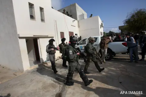 Israeli security forces stand guard outside a Palestinian burnt-out house belonging to a key witness to an arson attack which took place last year by Jewish extremists that killed a Palestinian family, in the Israeli occ...