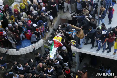 Mourners carry the body of Palestinian Ali Taqatqa, who the Israeli military said was shot dead with another Palestinian by Israeli troops after they stabbed and wounded an Israeli soldier on Thursday outside a Jewish se...