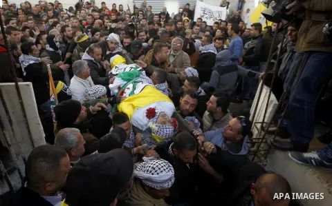Mourners carry the body of Palestinian Ali Taqatqa, who the Israeli military said was shot dead with another Palestinian by Israeli troops after they stabbed and wounded an Israeli soldier on Thursday outside a Jewish se...