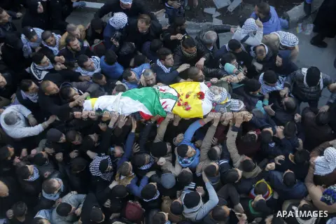 Mourners carry the body of Palestinian Ali Taqatqa, who the Israeli military said was shot dead with another Palestinian by Israeli troops after they stabbed and wounded an Israeli soldier on Thursday outside a Jewish se...