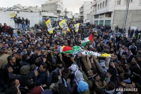 Mourners carry the body of Palestinian Ali Taqatqa, who the Israeli military said was shot dead with another Palestinian by Israeli troops after they stabbed and wounded an Israeli soldier on Thursday outside a Jewish se...