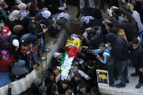 Mourners carry the body of Palestinian Ali Taqatqa, who the Israeli military said was shot dead with another Palestinian by Israeli troops after they stabbed and wounded an Israeli soldier on Thursday outside a Jewish se...