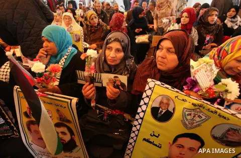 Palestinian women take part in a protest demanding release the prisoners in Israeli jails, in front of Red cross office, in Gaza city, on March 21, 2016. Photo by Ashraf Amra