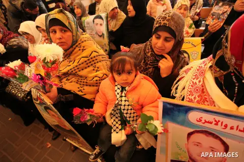 Palestinian women take part in a protest demanding release the prisoners in Israeli jails, in front of Red cross office, in Gaza city, on March 21, 2016. Photo by Ashraf Amra