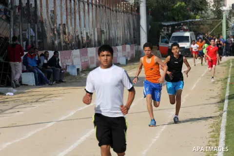 Palestinian youths take part in a local running championship at Yarmouk Stadium in Gaza city on March 21, 2016. Photo by Mohammed Asad