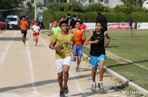 Palestinian youths take part in a local running championship at Yarmouk Stadium in Gaza city on March 21, 2016. Photo by Mohammed Asad