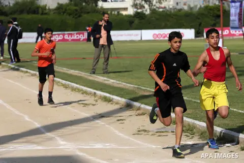 Palestinian youths take part in a local running championship at Yarmouk Stadium in Gaza city on March 21, 2016. Photo by Mohammed Asad