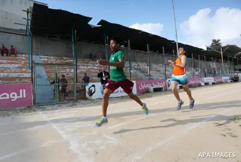 Palestinian youths take part in a local running championship at Yarmouk Stadium in Gaza city on March 21, 2016. Photo by Mohammed Asad