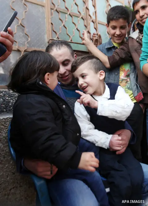 Palestinian boy Ahmed Dawabsha, 5, who suffered severe burns in an arson attack by suspected Jewish attackers on his family home last July and in which his younger brother, Ali, and his parents both died, is welcomed by...