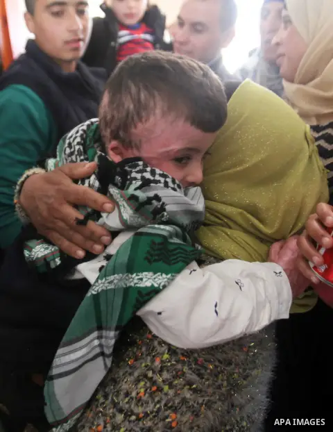 Palestinian boy Ahmed Dawabsha, 5, who suffered severe burns in an arson attack by suspected Jewish attackers on his family home last July and in which his younger brother, Ali, and his parents both died, is welcomed by...
