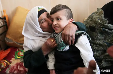 Palestinian boy Ahmed Dawabsha, 5, who suffered severe burns in an arson attack by suspected Jewish attackers on his family home last July and in which his younger brother, Ali, and his parents both died, is welcomed by...