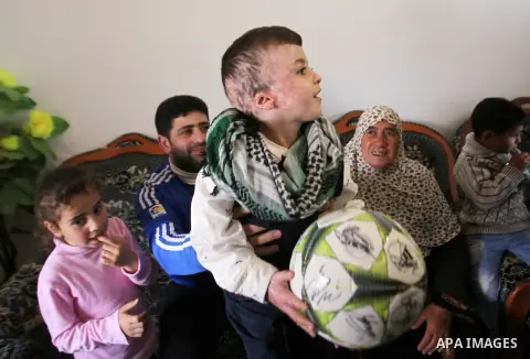 Palestinian boy Ahmed Dawabsha, 5, who suffered severe burns in an arson attack by suspected Jewish attackers on his family home last July and in which his younger brother, Ali, and his parents both died, is welcomed by...