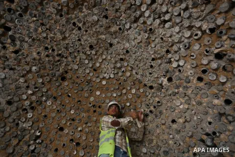 A Palestinian worker renovates the archaeological Maqam Al-Khader, in Deir al-Balah, central Gaza on March 24, 2016. Maqam Al-Kader is one of the monuments of the city of Deir al-Balah, the Ministry of Tourism and Antiqu...