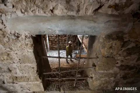 A Palestinian worker renovates the archaeological Maqam Al-Khader, in Deir al-Balah, central Gaza on March 24, 2016. Maqam Al-Kader is one of the monuments of the city of Deir al-Balah, the Ministry of Tourism and Antiqu...