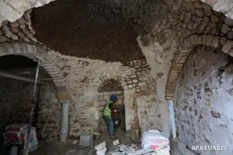 A Palestinian worker renovates the archaeological Maqam Al-Khader, in Deir al-Balah, central Gaza on March 24, 2016. Maqam Al-Kader is one of the monuments of the city of Deir al-Balah, the Ministry of Tourism and Antiqu...