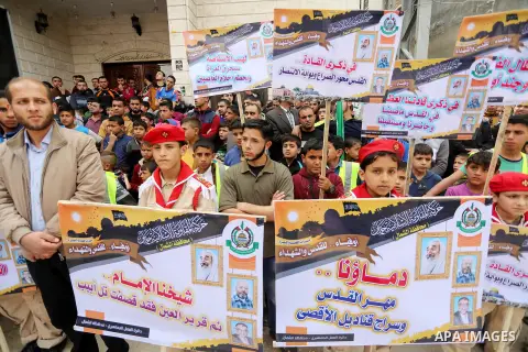 Palestinian supporters of Hamas movement take part during a rally to mark the 12th anniversary of the death of assassinated Hamas spiritual leader Sheikh Ahmed Yassine and show solidarity with Palestinians in Jerusalem a...