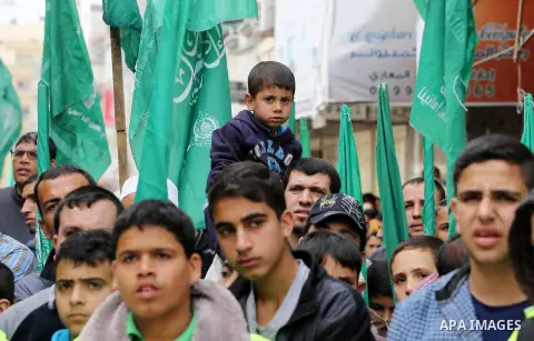 Palestinian supporters of Hamas movement take part during a rally to mark the 12th anniversary of the death of assassinated Hamas spiritual leader Sheikh Ahmed Yassine and show solidarity with Palestinians in Jerusalem a...
