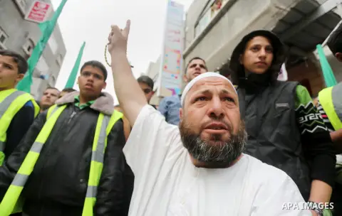 Palestinian supporters of Hamas movement take part during a rally to mark the 12th anniversary of the death of assassinated Hamas spiritual leader Sheikh Ahmed Yassine and show solidarity with Palestinians in Jerusalem a...