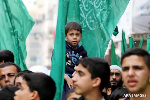 Palestinian supporters of Hamas movement take part during a rally to mark the 12th anniversary of the death of assassinated Hamas spiritual leader Sheikh Ahmed Yassine and show solidarity with Palestinians in Jerusalem a...