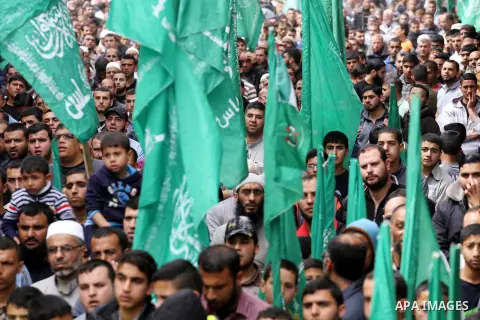 Palestinian supporters of Hamas movement take part during a rally to mark the 12th anniversary of the death of assassinated Hamas spiritual leader Sheikh Ahmed Yassine and show solidarity with Palestinians in Jerusalem a...