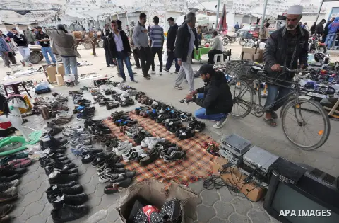 Palestinian vendors display all kinds of used goods at El-Yarmouk market in Gaza city, on March 26, 2016. Photo by Mohammed Asad