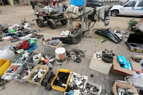 Palestinian vendors display all kinds of used goods at El-Yarmouk market in Gaza city, on March 26, 2016. Photo by Mohammed Asad