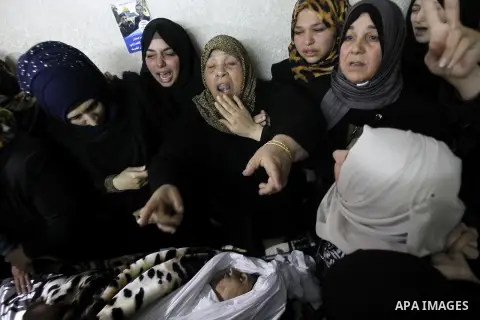 Relatives mourn next the body of Ramzi al-Qasrawi, 21, a Palestinian man who was killed in a reported stabbing attack, during his funeral in the West Bank town of Hebron on March 26, 2016. Ramzi al-Qasrawi was killed on...