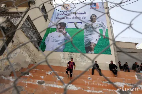 Palestinian chlidren hold ballons and posters bearing a portrait of Palestinian boy Ahmed Dawabsha, 5, who suffered severe burns in an arson attack by suspected Jewish attackers on his family home last July and in which...