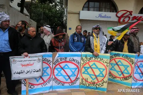 Palestinian families of martyrs, hold banners during a protest to demand their salaries, in front of Red cross office, in Gaza city, on March 28, 2016. Photo by Mohammed Asad