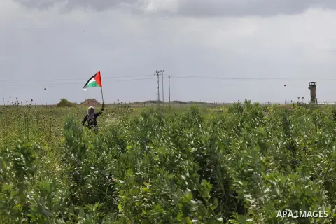 Palestinians hold national flags during a march to mark Land Day in Gaza, on March 29, 2016. The annual demonstrations mark the deaths of six Arab Israeli protesters at the hands of Israeli police and troops during mass...