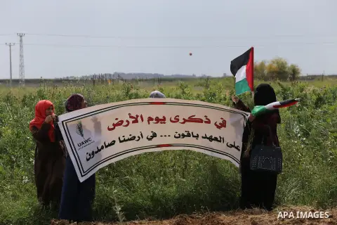Palestinians hold national flags during a march to mark Land Day in Gaza, on March 29, 2016. The annual demonstrations mark the deaths of six Arab Israeli protesters at the hands of Israeli police and troops during mass...