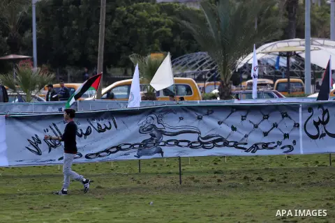 A Palestinian man walks past a mural during a rally marking Land Day, in Gaza City March 30, 2016. March 30 marks Land Day, the annual commemorations of the killing by police of six Arab citizens in 1976 during protests...