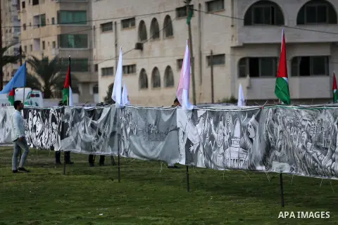 A Palestinian man walks past a mural during a rally marking Land Day, in Gaza City March 30, 2016. March 30 marks Land Day, the annual commemorations of the killing by police of six Arab citizens in 1976 during protests...