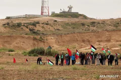 Demonstrators holding Palestinian flags chant slogans during a rally marking Land Day, near the Israeli border with central Gaza Strip March 30, 2016. March 30 marks Land Day, the annual commemorations of the killing by...