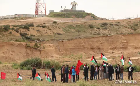 Demonstrators holding Palestinian flags chant slogans during a rally marking Land Day, near the Israeli border with central Gaza Strip March 30, 2016. March 30 marks Land Day, the annual commemorations of the killing by...